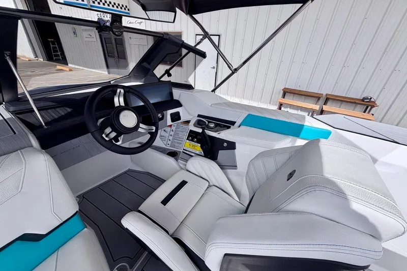 Slide: The Image of 2026 Nautique Ski Nautique boat interior with modern steering and seating design. - 11