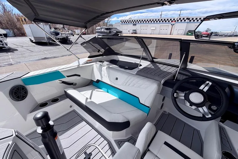 Slide: The Image of 2026 Nautique Ski Nautique boat interior with modern seating and steering wheel. - 12