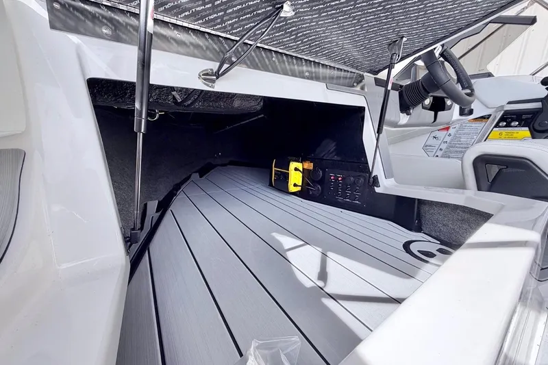 Slide: The Image of 2026 Nautique Ski Nautique interior with open storage compartment and sleek dashboard design. - 16