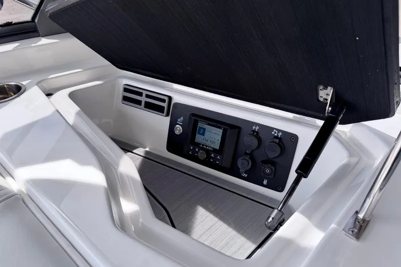 Slide: The Image of 2026 Nautique Ski Nautique boat dashboard with audio controls and USB ports. - 17