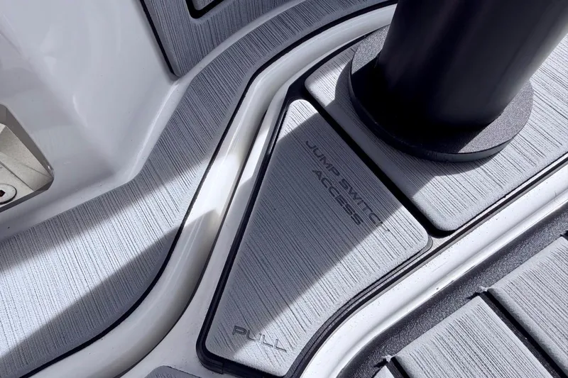 Slide: The Image of 2026 Nautique Ski Nautique boat interior with jump switch access panel. - 25