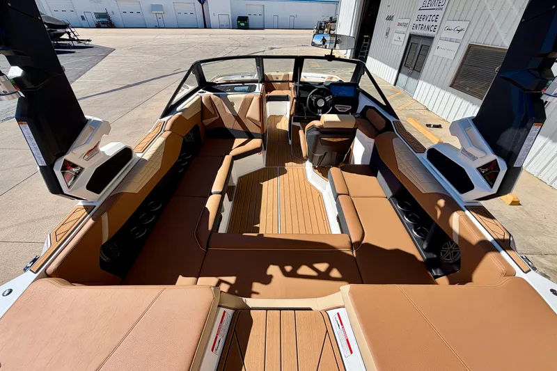 Slide: The Image of 2026 Nautique Super Air Nautique S21 interior with tan seating and modern dashboard. - 10