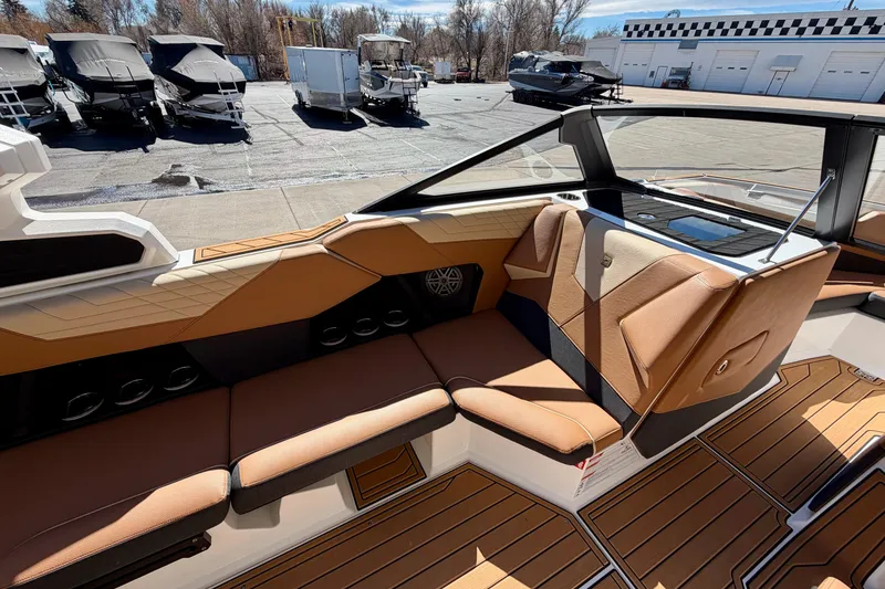 Slide: The Image of 2026 Nautique Super Air Nautique S21 interior with tan seating and sleek design. - 12