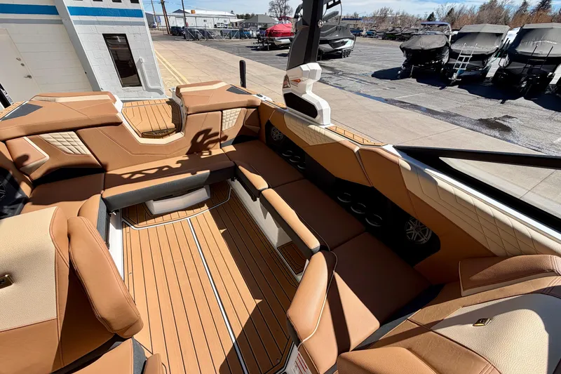 Slide: The Image of 2026 Nautique Super Air Nautique S21 interior with tan upholstery and sleek design. - 13