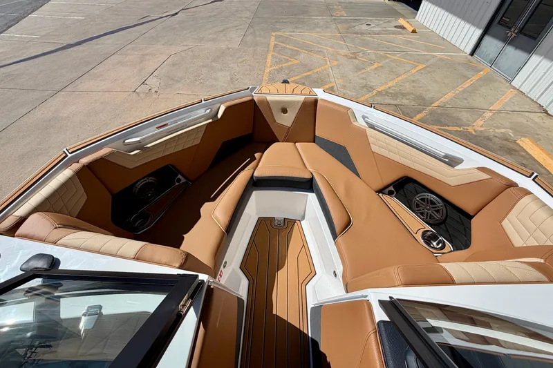 Slide: The Image of 2026 Nautique Super Air Nautique S21 boat interior with tan seating and modern design. - 14