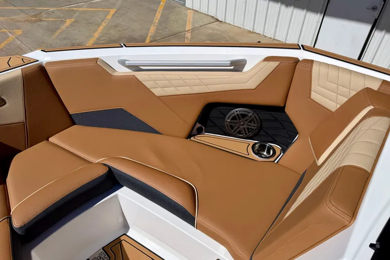 Slide: The Image of 2026 Nautique Super Air Nautique S21 interior with tan leather seating and speaker system. - 15