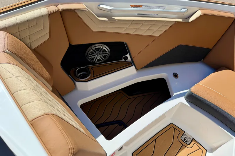 Slide: The Image of Luxurious interior of 2026 Nautique Super Air Nautique S21 with tan upholstery and speaker system. - 18