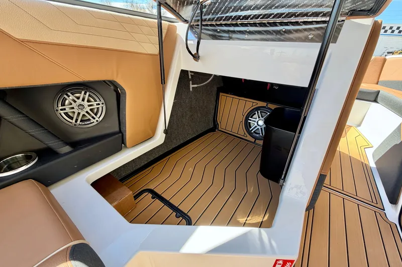 Slide: The Image of Interior view of 2026 Nautique Super Air Nautique S21 boat, featuring premium seating and speakers. - 21