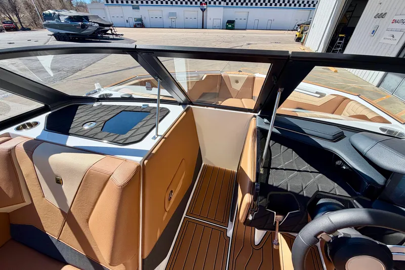 Slide: The Image of Interior of 2026 Nautique Super Air Nautique S21 boat, featuring luxurious seating and dashboard. - 22