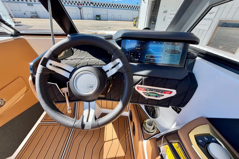 Slide: The Image of 2026 Nautique Super Air Nautique S21 dashboard with steering wheel and touchscreen display. - 25