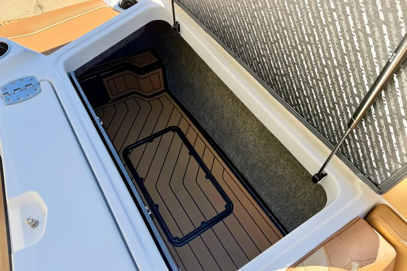 Slide: The Image of Open storage compartment in 2026 Nautique Super Air Nautique S21 boat. - 30