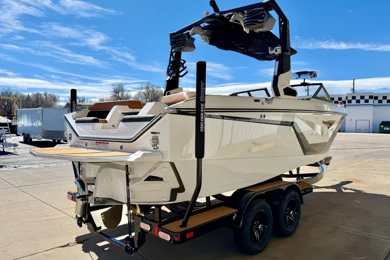 Slide: The Image of 2026 Nautique Super Air Nautique S21 boat on trailer, sunny day, outdoor setting. - 6