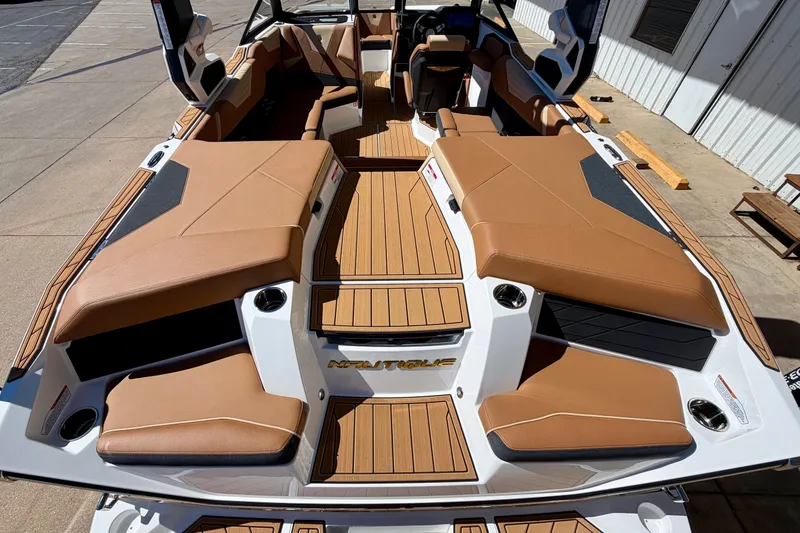 Slide: The Image of 2026 Nautique Super Air Nautique S21 boat with tan seating and teak flooring. - 9