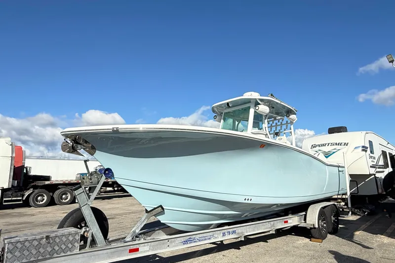 The Image of 2017 Tidewater 280 CC Adventure boat on trailer under clear blue sky. - 0