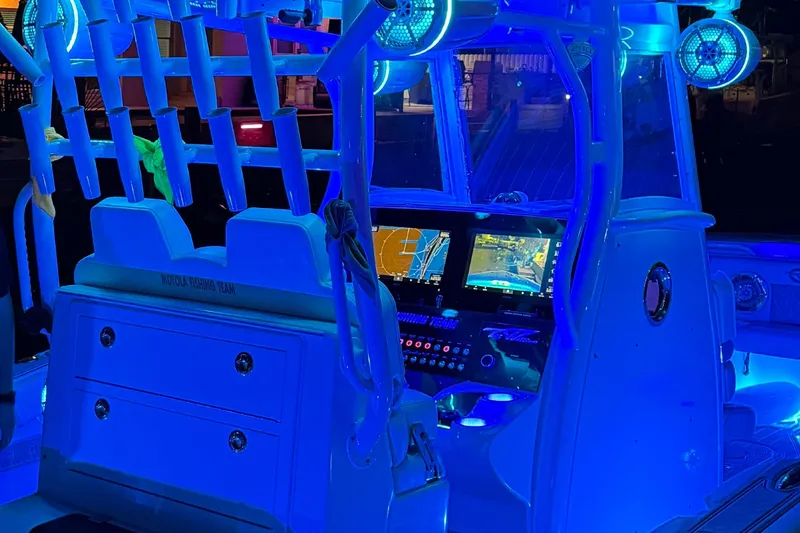 Slide: The Image of 2017 Tidewater 280 CC Adventure boat interior with illuminated control panel and rod holders. - 14