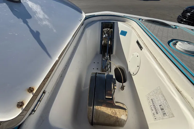 Slide: The Image of 2017 Tidewater 280 CC Adventure boat anchor compartment with chain and winch. - 17