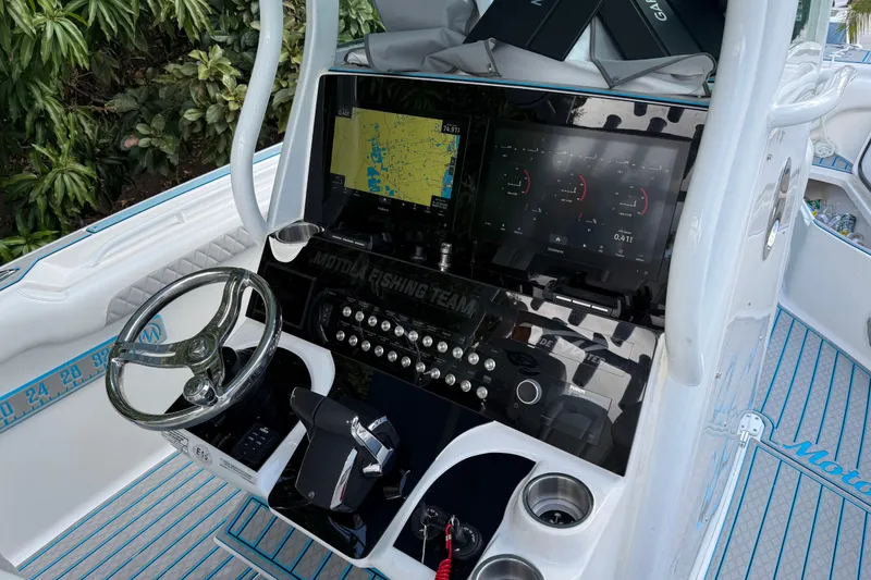 Slide: The Image of 2017 Tidewater 280 CC Adventure boat dashboard with navigation screens and controls. - 3