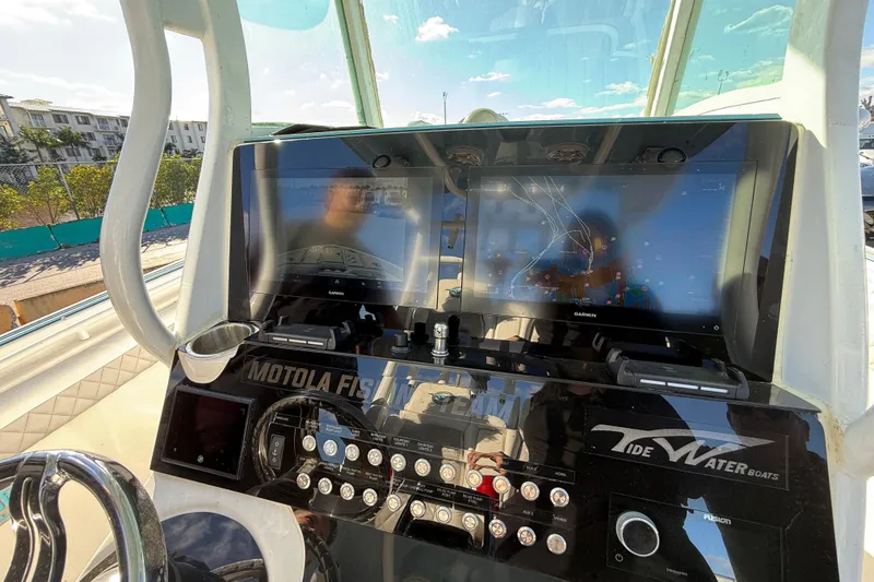 Slide: The Image of 2017 Tidewater 280 CC Adventure boat dashboard with Garmin navigation display and control panel. - 5