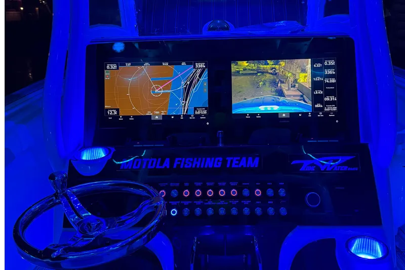 Slide: The Image of 2017 Tidewater 280 CC Adventure dashboard with navigation screens and blue LED lighting. - 9