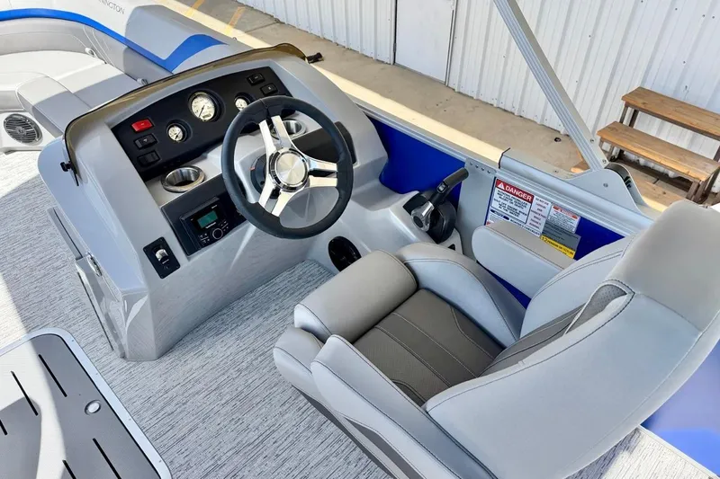 Slide: The Image of 2026 Bennington 22 SX Swingback boat interior with steering wheel and control panel. - 13
