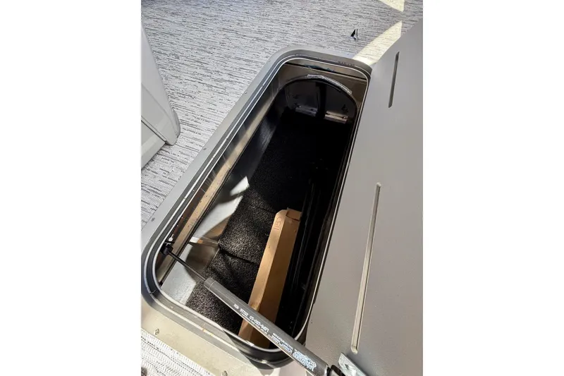 Slide: The Image of Open storage compartment on 2026 Bennington 22 SX Swingback boat. - 18
