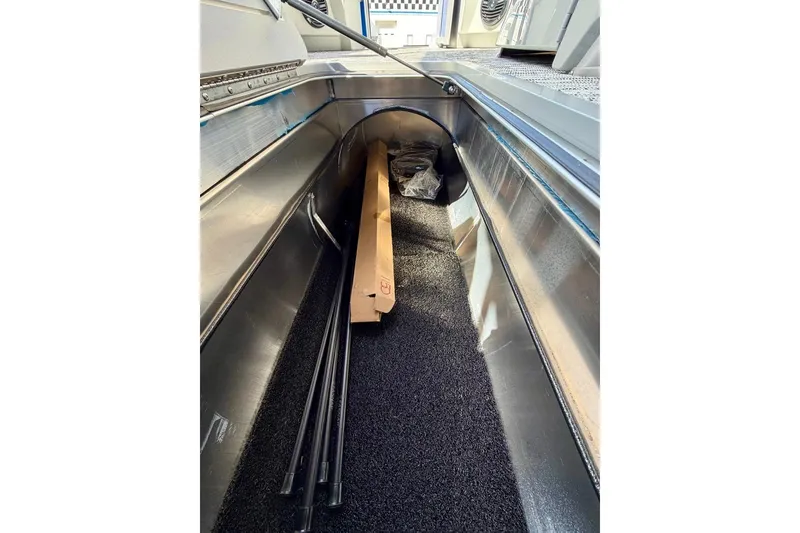 Slide: The Image of Interior storage compartment of 2026 Bennington 22 SX Swingback boat, featuring sleek design. - 19