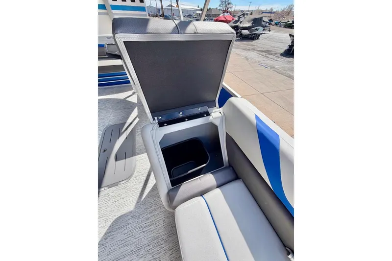 Slide: The Image of 2026 Bennington 22 SX Swingback boat seat with open storage compartment. - 21