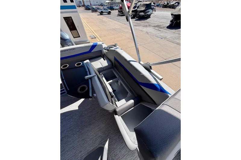Slide: The Image of 2026 Bennington 22 SX Swingback boat interior with seating and storage compartments. - 22