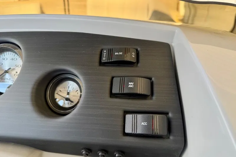 Slide: The Image of Dashboard controls of 2026 Bennington 22 SX Swingback boat, featuring switches and gauges. - 27