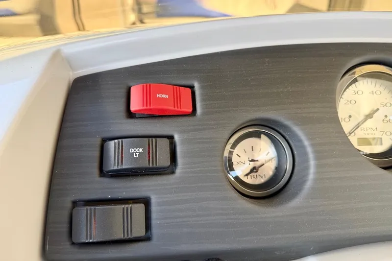 Slide: The Image of Dashboard controls of 2026 Bennington 22 SX Swingback boat, featuring horn and dock light switches. - 28