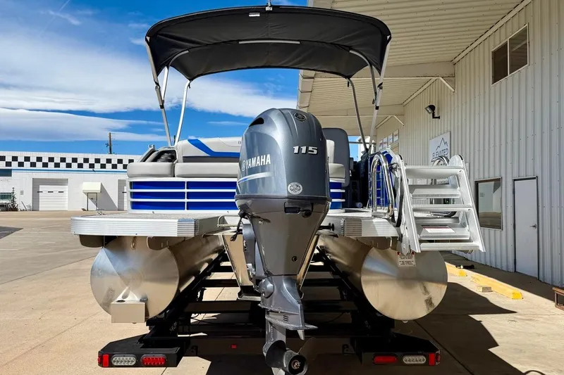 Slide: The Image of 2026 Bennington 22 SX Swingback pontoon boat with Yamaha 115 engine, docked outdoors. - 7