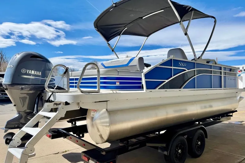 Slide: The Image of 2026 Bennington 22 SX Swingback pontoon boat with Yamaha motor on trailer. - 9