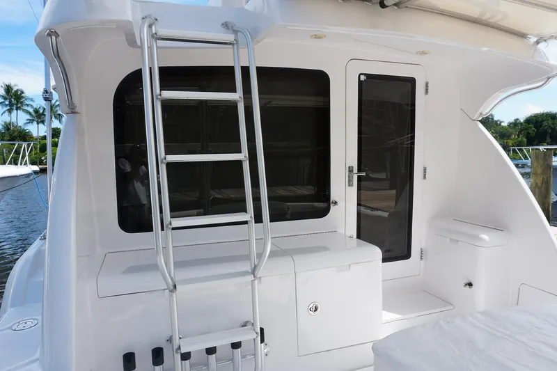 Slide: The Image of 2005 Mirage Yachts 40 Convertible, rear view with ladder and door, docked in marina. - 10