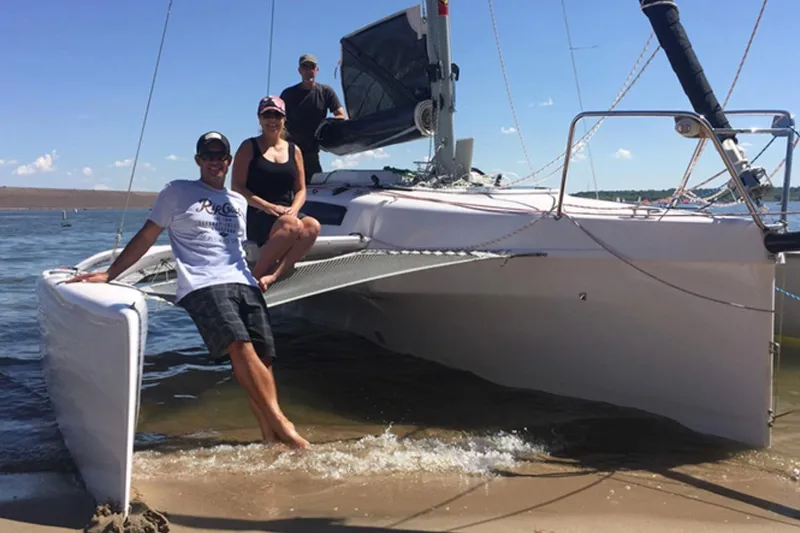 The Image of People enjoying a day on a 2022 Corsair 760 trimaran at the beach. - 0