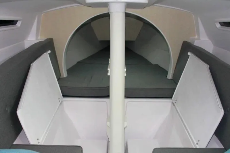 Slide: The Image of Interior of 2022 Corsair 760 sailboat, featuring compact cabin with storage and seating. - 5
