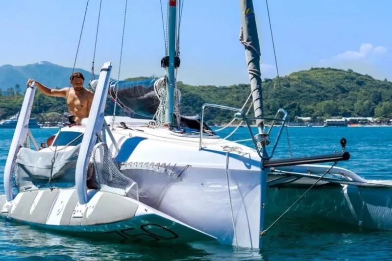 Slide: The Image of Man sailing Corsair 760 trimaran on a sunny day, 2022 model. - 7