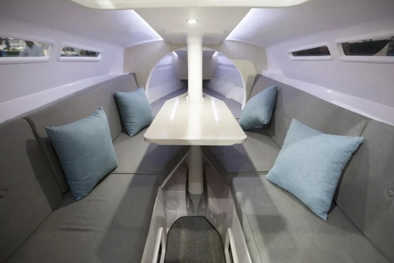 Slide: The Image of Interior of 2022 Corsair 760 sailboat with cozy seating and cushions. - 8