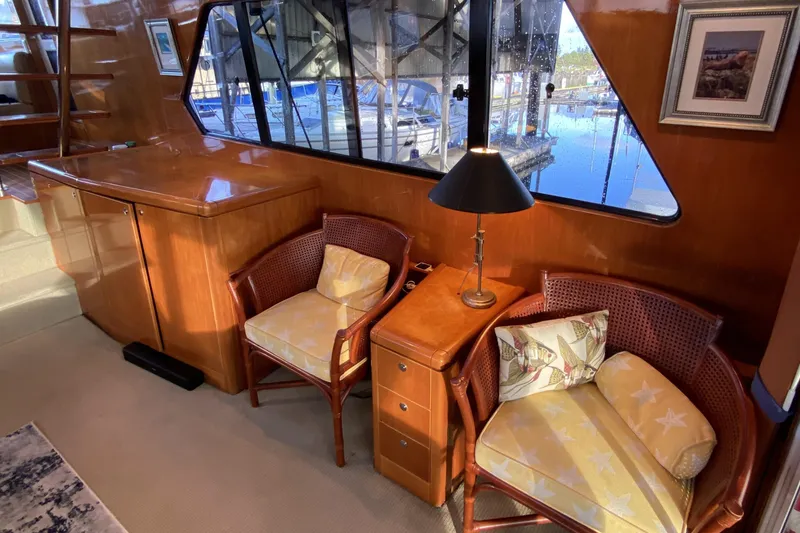 Slide: The Image of Interior of a 2000 Compass 55 yacht with cozy seating and elegant wood finish. - 10