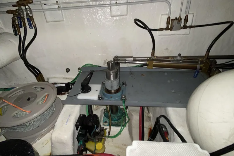 Slide: The Image of Engine room of a 2000 Compass 55 boat, featuring mechanical components and wiring. - 101