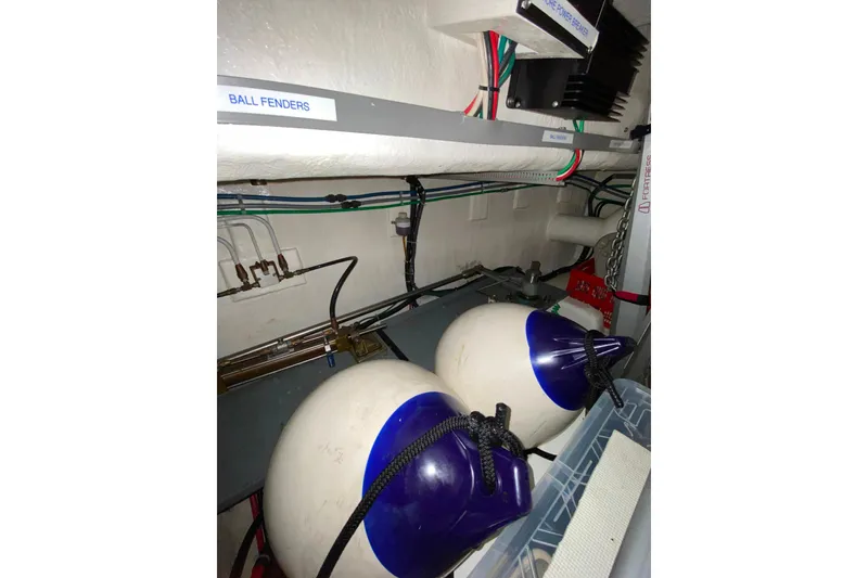 Slide: The Image of Storage area with ball fenders and wiring in a 2000 Compass 55 boat. - 102