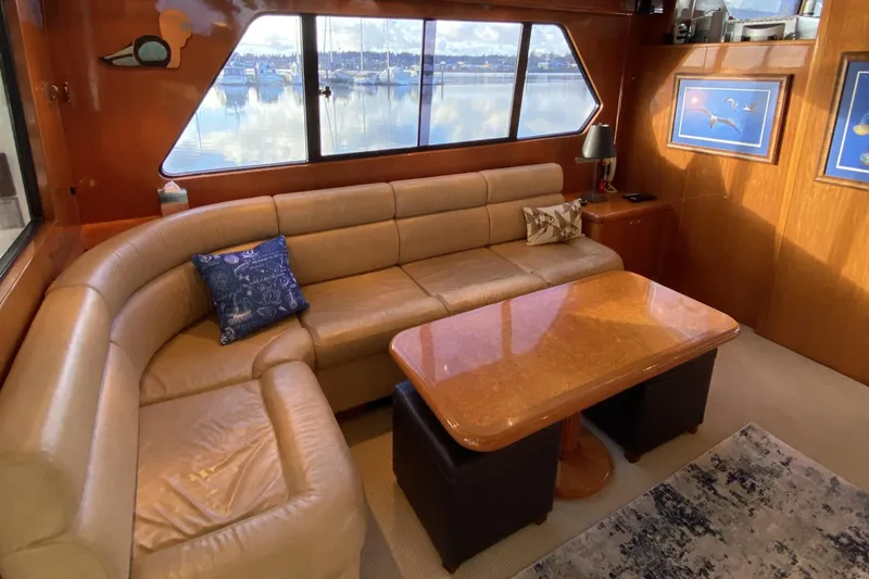 Slide: The Image of Luxurious interior of 2000 Compass 55 yacht with leather seating and scenic window view. - 11