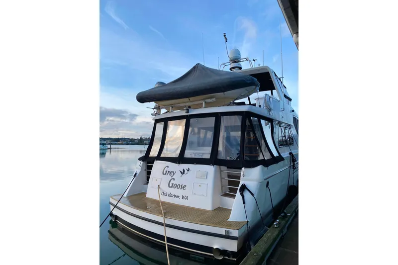 Slide: The Image of Compass 55 yacht, 2000 model, docked at marina with "Grey Goose" signage. - 113
