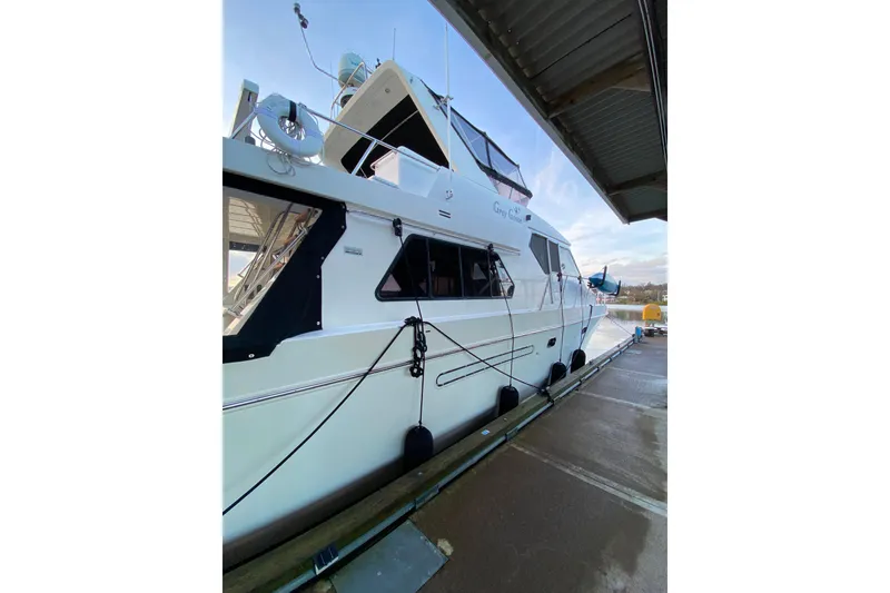 Slide: The Image of Luxury Compass 55 yacht docked, 2000 model, featuring sleek design and modern amenities. - 115