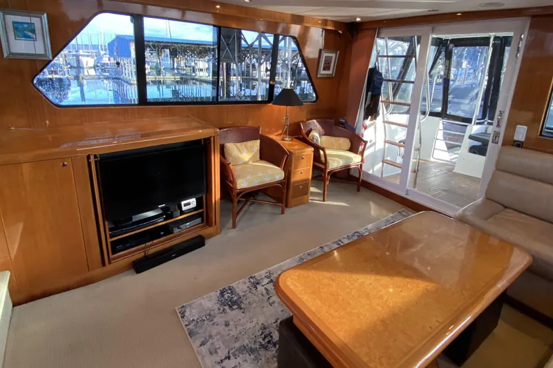 Slide: The Image of Luxurious interior of 2000 Compass 55 yacht with TV, seating, and marina view. - 12