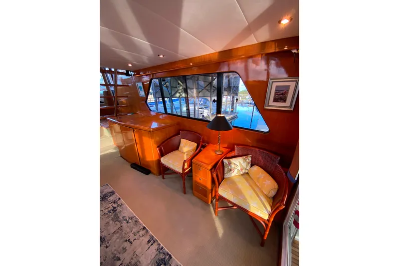 Slide: The Image of Luxurious interior of 2000 Compass 55 yacht with elegant wood finish and cozy seating. - 15