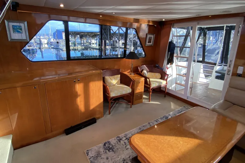 Slide: The Image of Luxurious interior of 2000 Compass 55 yacht with elegant wood finishes and marina view. - 16