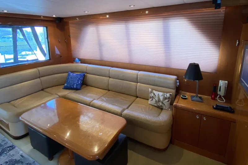 Slide: The Image of Luxurious yacht interior with beige leather seating, wooden table, and modern decor. Compass 55, 2000 model. - 18