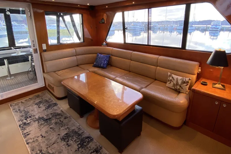 Slide: The Image of Luxurious interior of 2000 Compass 55 yacht with leather seating and scenic marina view. - 21
