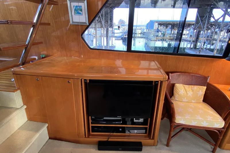 Slide: The Image of Luxurious interior of 2000 Compass 55 yacht with wooden cabinetry and entertainment center. - 22