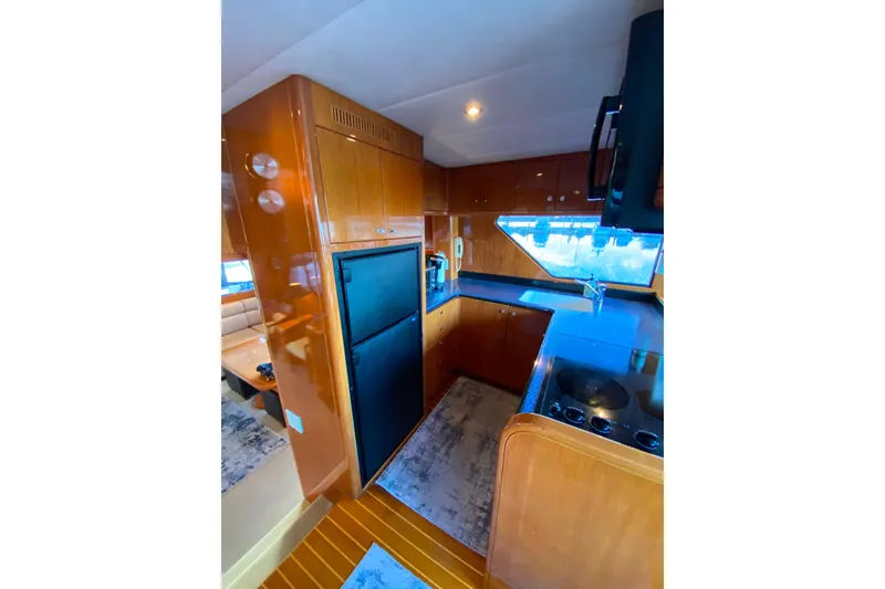 Slide: The Image of Luxurious kitchen interior of 2000 Compass 55 yacht with modern appliances and wood finish. - 24